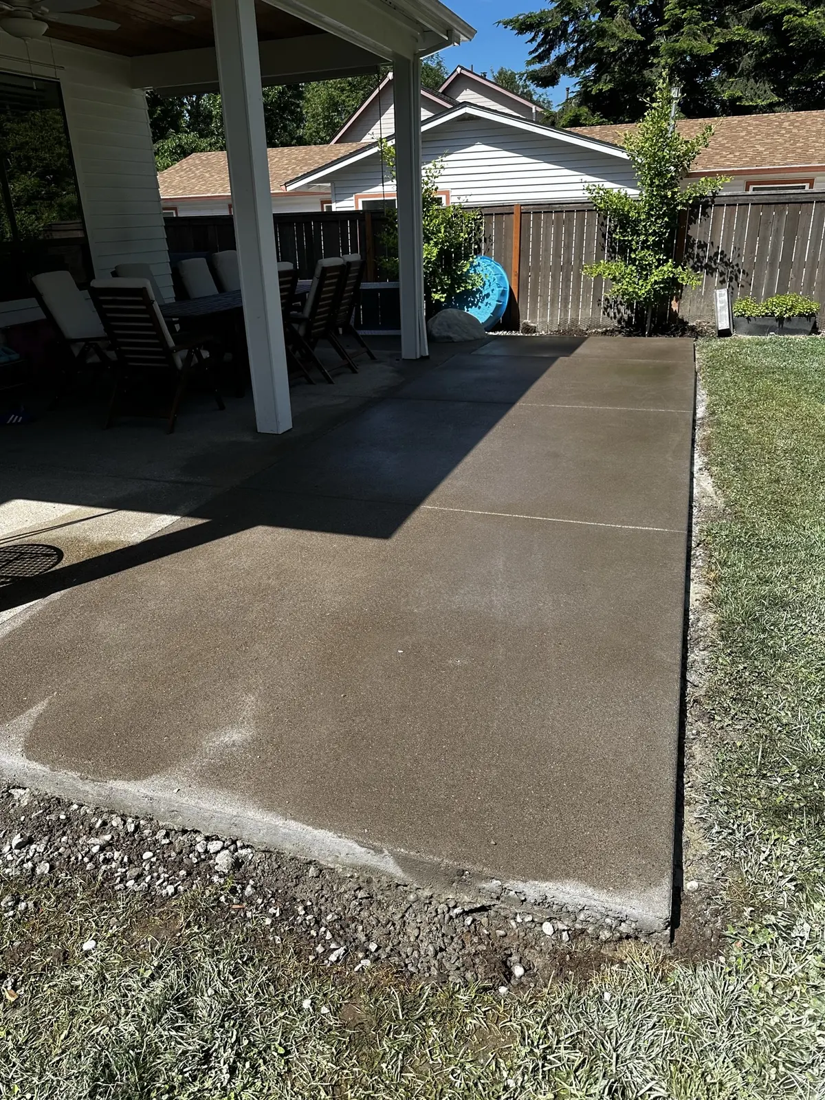 Concrete outdoor surface extending beneath a covered patio from Maximus’s gallery